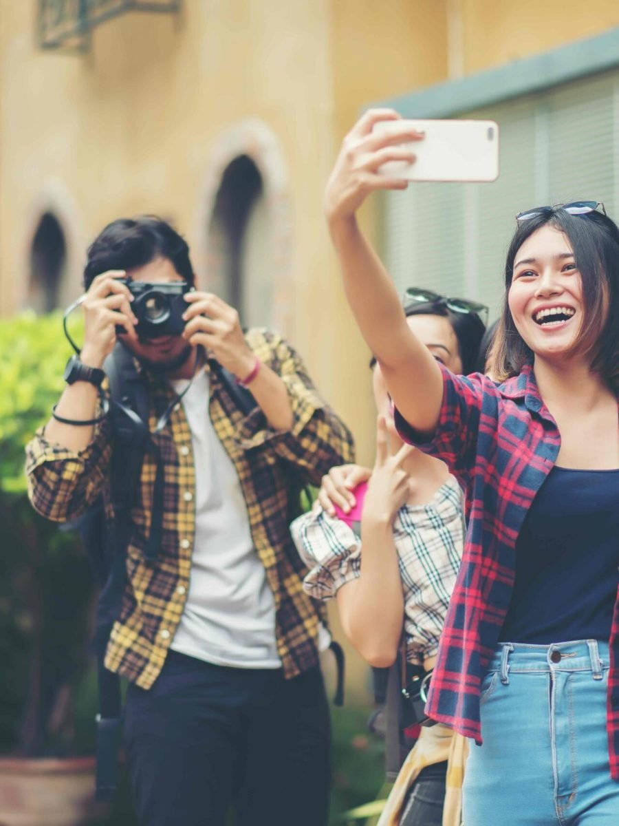 Group of friends taking selfie in a urban street having good fun together.